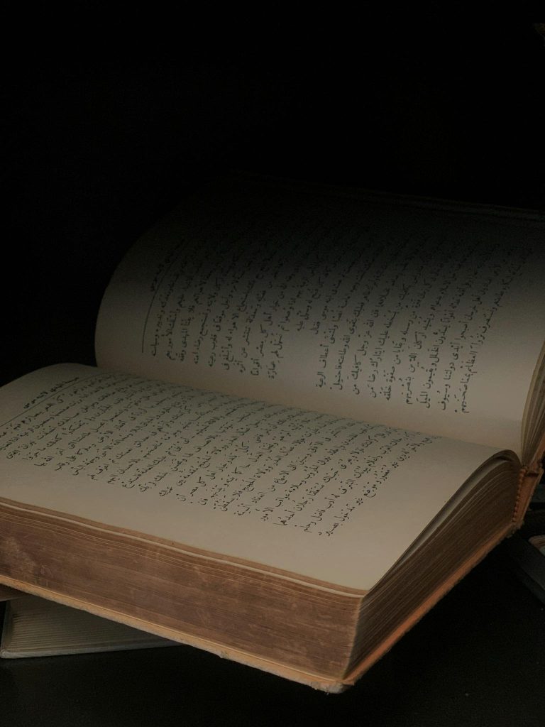 An open book with ancient script, creating a sense of mystery and wisdom.